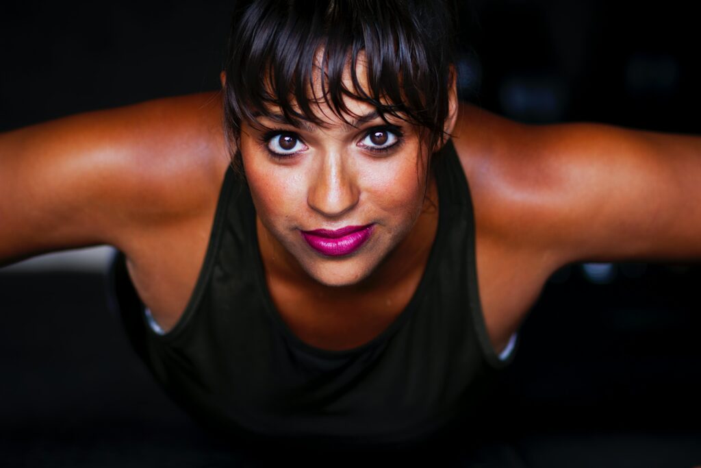 a women facing the camera smiling doing a plank for a plank challenge