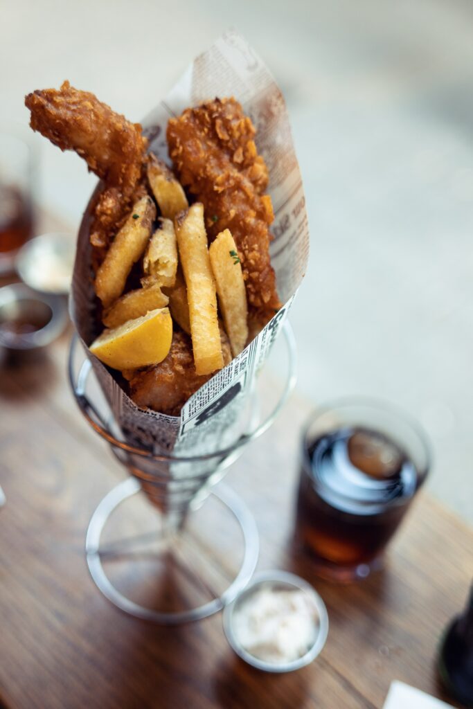 fish and chips in a restaurant with soda