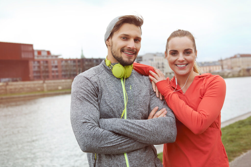 A man and a woman doing exercise and taking care of their heart for a better health