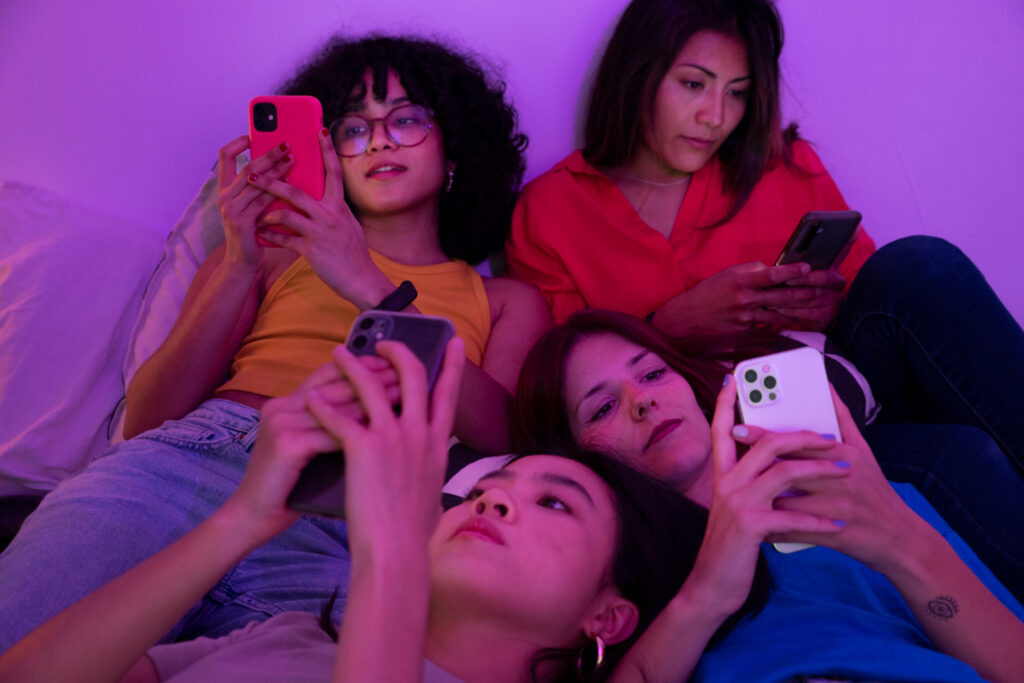 A group of gen Z persons using smartphones, one of the 10 technologies that change our world