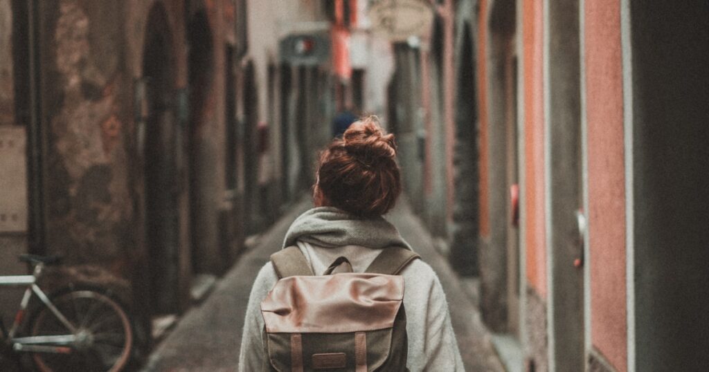 Solo traveler with backpack hiking mountain trail adventure